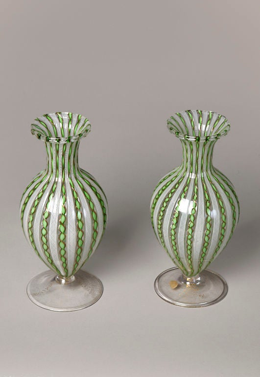 Pair of bulbous form glass vases with green and gold zanfirico and fine white latticino, flaired rims, clear bases with gold inclusions. By AVEM, Murano, Italy 1960s. One retaining round red Made in Murano label, 4 in. largest diameter, 9.25 in.