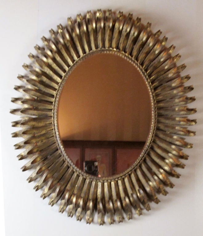 A very decorative and elegant metal eyelash mirror made in Spain during the mid-century.  This mirror is reminiscent of Italian metal work or the designs of Curtis Jere.