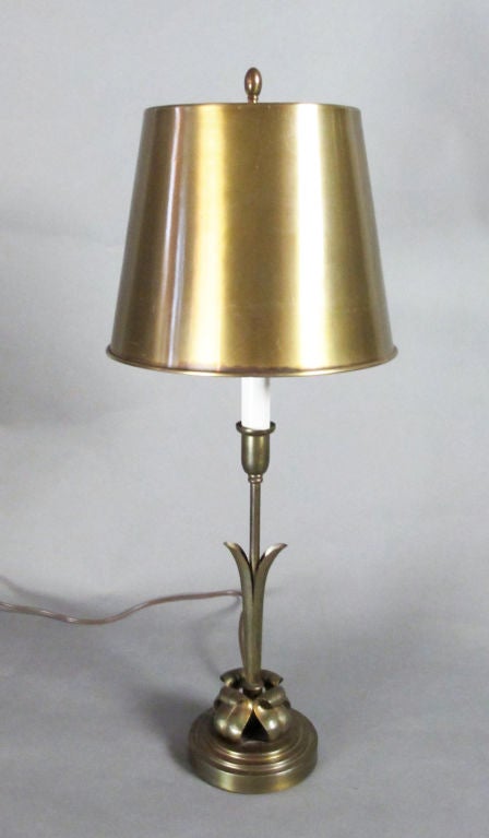 A handcrafted brass lamp by Grag Studios with what appears to be the original spun brass shade.  Hans Grag immigrated to the United States from Germany in the late 1920's.  Evidence of his German training can be seen in design details, with