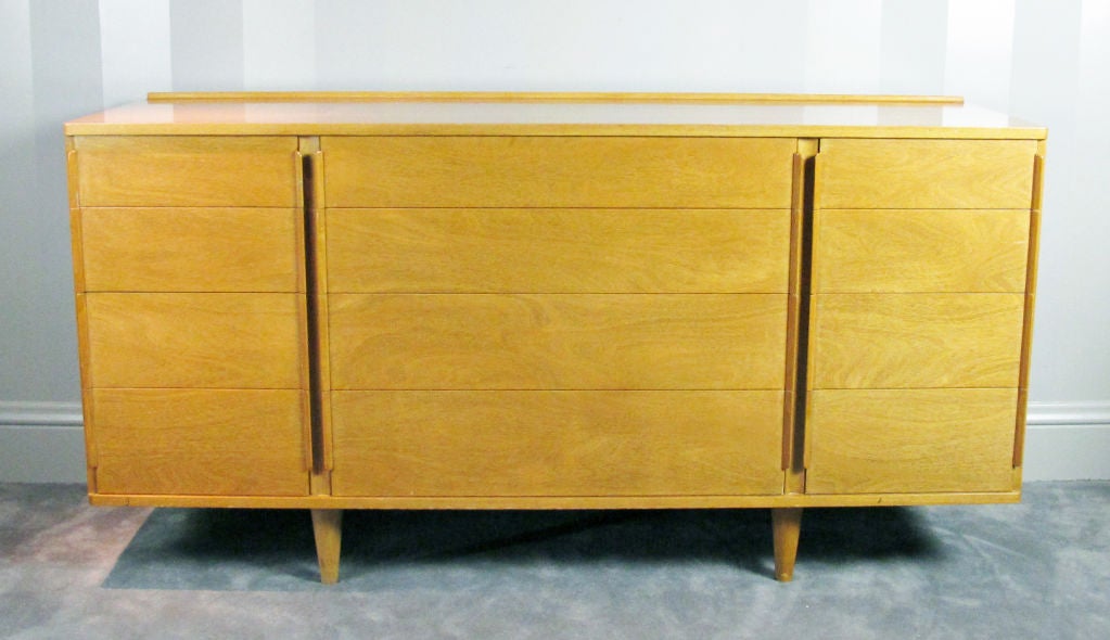 A well-made dresser or chest of drawers in bleached mahogany by Edward Wormley for Dunbar.  Consists of four center drawers with finger handles flanked by four drawers on each side.  Dunbar label in top left-hand drawer.  Excellent vintage