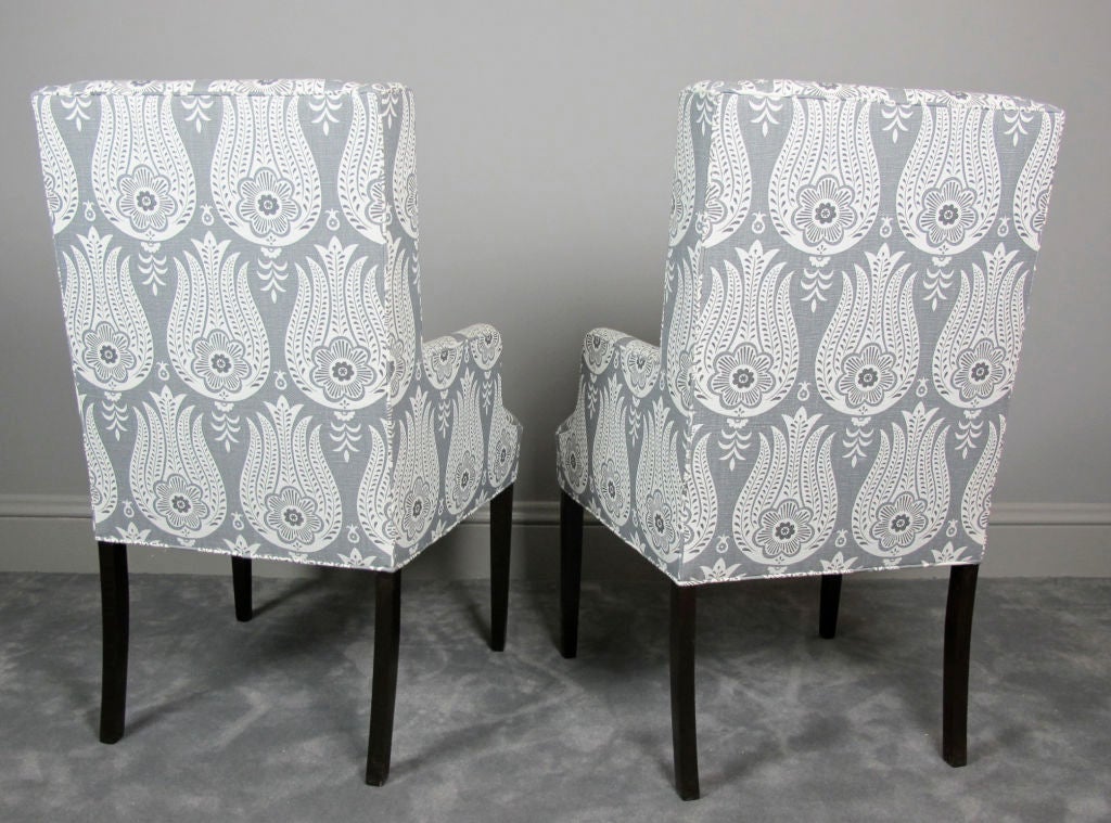 Pair of 1960's modern high back wing chairs upholstered in a Matt Murphy Studio hand-screened 15- ounce Belgian linen.  Legs refinished in dark mahogany.  Fabric also available by the yard.