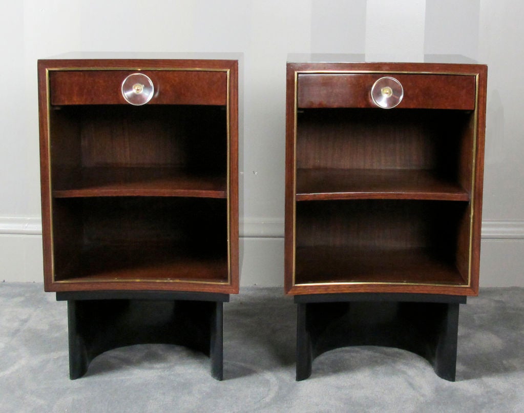 A beautiful pair of nightstands designed by Gilbert Rohde for Herman Miller, circa 1939.  Made of East Indian rosewood and sequoia burl, these are from one of Rohde's most elegant bedroom collections.  One nightstand retains original Rohde label.