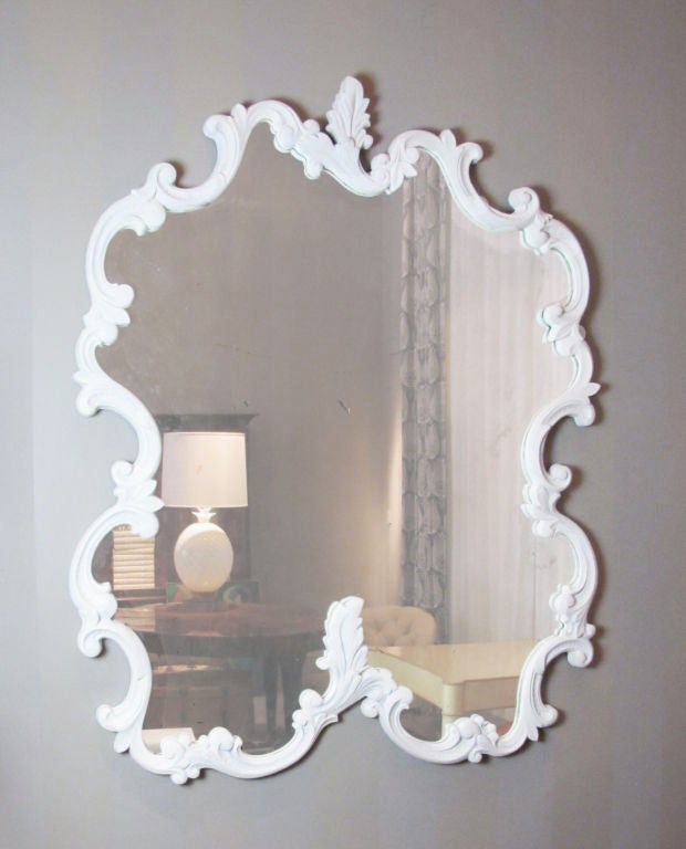 This is a very large and decorative plaster mirror quite possibly by Dorothy Draper.  This example was removed from a San Francisco area theatre.  Although the mirror is plaster, it was gold gilt at one time, and then painted white in a plaster-like