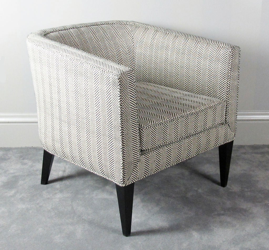 Here's a very elegant lounge chair designed by Edward Wormley for Dunbar.  Chair has been reupholstered in a cotton/linen herringbone blend by Malabar.  Original black lacquer finish on legs.  Chair retains original woven Dunbar label.