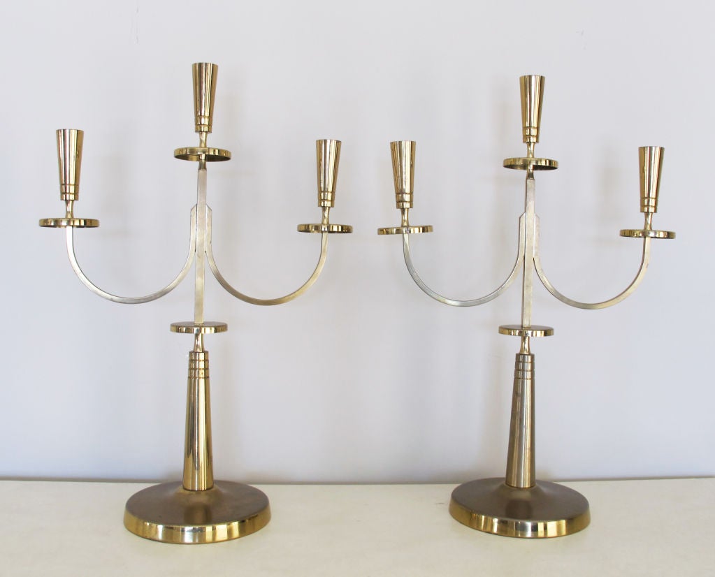 A lovely and large pair of candelabra by Tommi Parzinger for Dorlyn.  Each candle stand holds three taper candles.  Signed.