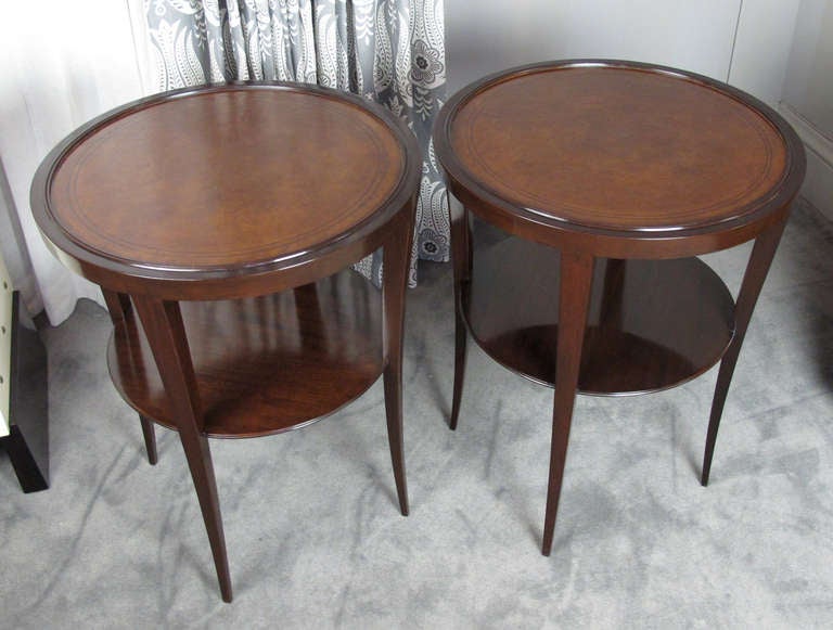 Here's an elegant pair of side tables by Tommi Parzinger for Charak, c. 1940.  Design features a leather top in a deep caramel color with a lower second shelf.  Beautifully refinished.  One label retains original Charak label and states date of
