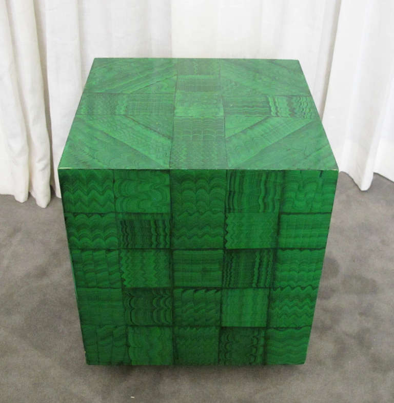 This is a very well-made and highly decorative cube in faux malachite. Seemingly hand-painted, the malachite technique is tiled to dramatic effect. The cube shape is mounted on an ebonized wood plinth. Although the faux malachite technique is