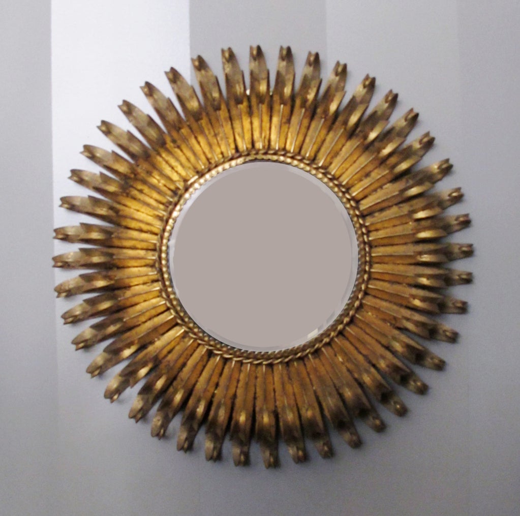 This is a very decorative and elegant metal eyelash mirror made in Spain during the mid-century. This mirror is reminiscent of Italian metal work or the designs of Curtis Jere.  Retains metal MADE IN SPAIN tag.
