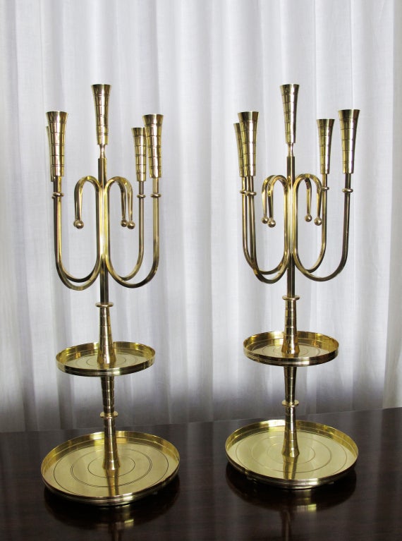 This is a hard-to-find Dorlyn design by Tommi Parzinger.  Each candelabrum holds five taper candles and have two tired trays for hors d' oeuvres or candies.   Recently polished and lacqured to prevent tarnishing.  Priced as a pair.