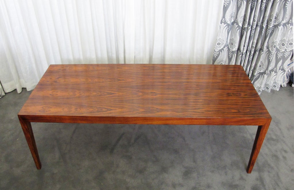 This is a simple and elegant cocktail or coffee table in rosewood.  In very good original condition.