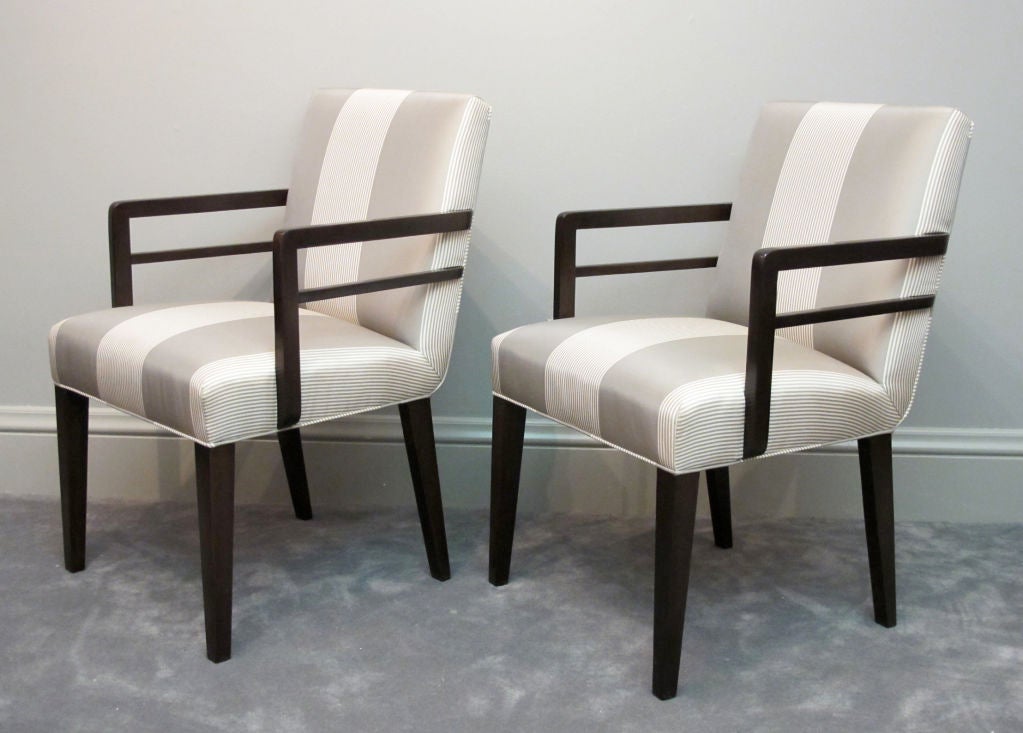 An early, stylish pair of Widdicomb armchairs designed by Robsjohn-Gibbings. These were no doubt captain's chairs for a dining suite, but would also work well as side or pull-up chairs. Reupholstered in a grey and ivory striped silk, which has been