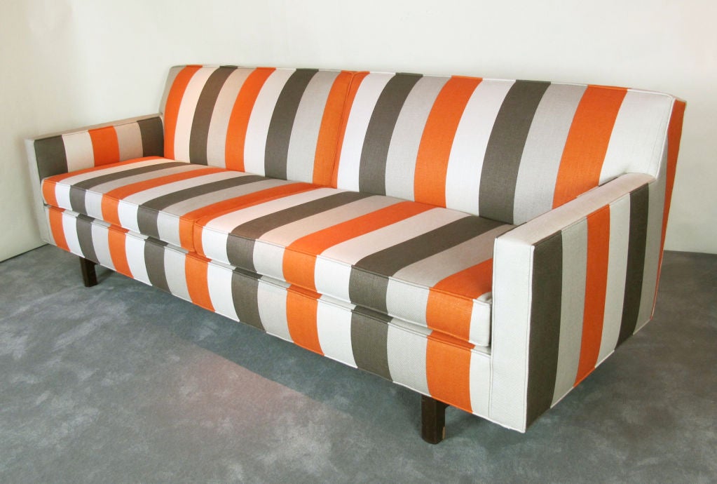 An Edward Wormley designed sofa newly upholstered in a Roma striped linen.  Original finish to stretcher base.  Original Dunbar deck cloth was retained during reupholstering.