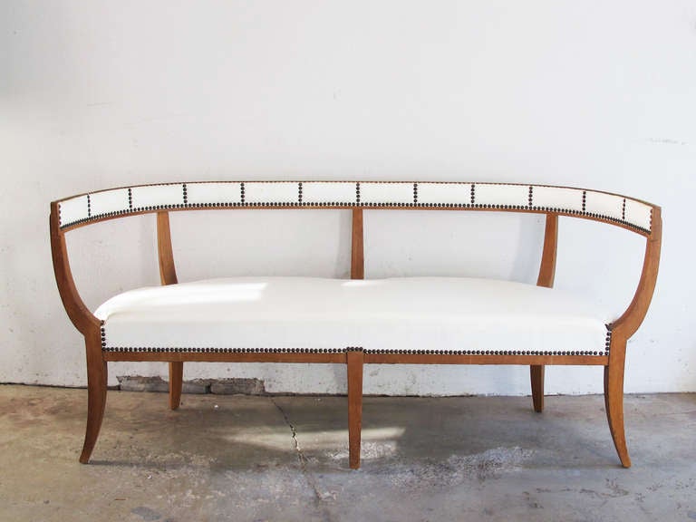 This is a rare and beautifully designed settee or bench with a strong attribution to Edward Wormley for Dunbar.  A similar model is illustrated in the April 1939 House & Garden magazine as part of their 