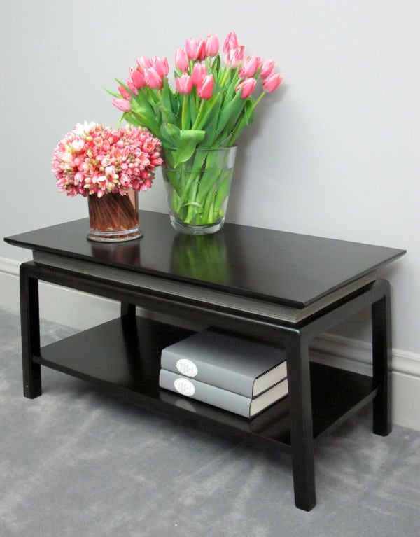 Paul Frankl designed cocktail or coffee table. Refinished in a van dyke brown finish with antique silver combed wood accent.