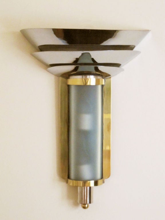 A nice, large sconce from the machine age.  This lamp has two light sources--an up-light as well as a glass diffuser which houses two more bulbs.  The sconce was restored recently--the brass parts polished and the nickel components replated.   Ready