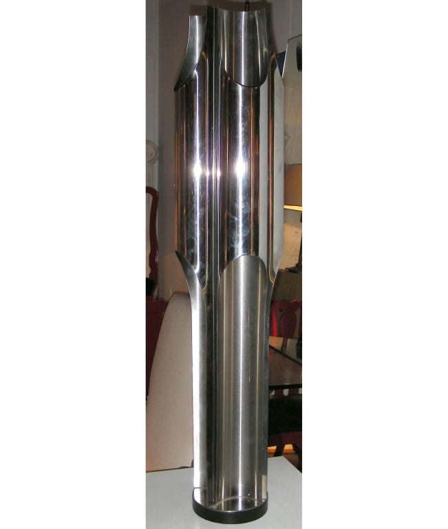 A stainless steel floor lamp by Jacques charles for maison charles
