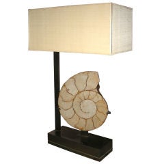 A BRASS LAMP WITH FOSSIL DECORATION