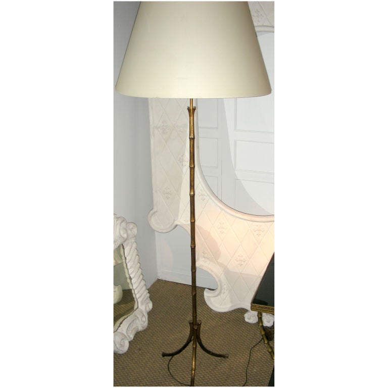A FAUX BAMBOO PATINATED METAL TRIPOD FLOOR LAMP