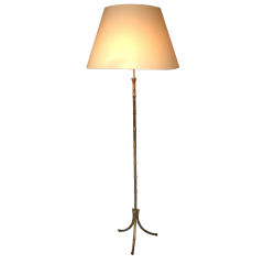 A FAUX BAMBOO PATINATED METAL TRIPOD FLOOR LAMP