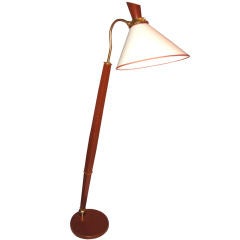 A LEATHER AND BRASS FLOOR LAMP