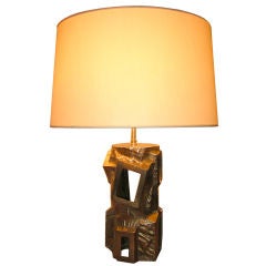 A SMALL BRASS LAMP BY PEGUY BURKE