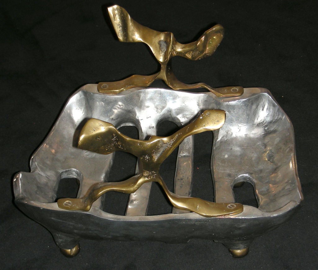 A MAGAZINE RACK IN CAST IRON AND BRASS