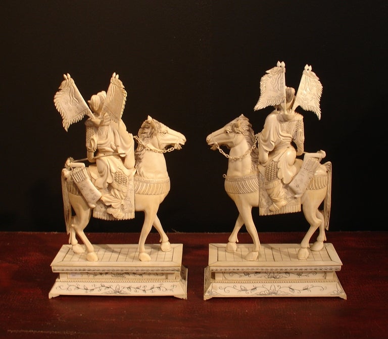 A well carved pair of Chinese warriors mounted on horseback. Dressed in full battle regalia, replete with arms, armor and flags. The horses are expressive and display a wonderful sense of movement. 

Each horse and figure are carved from solid