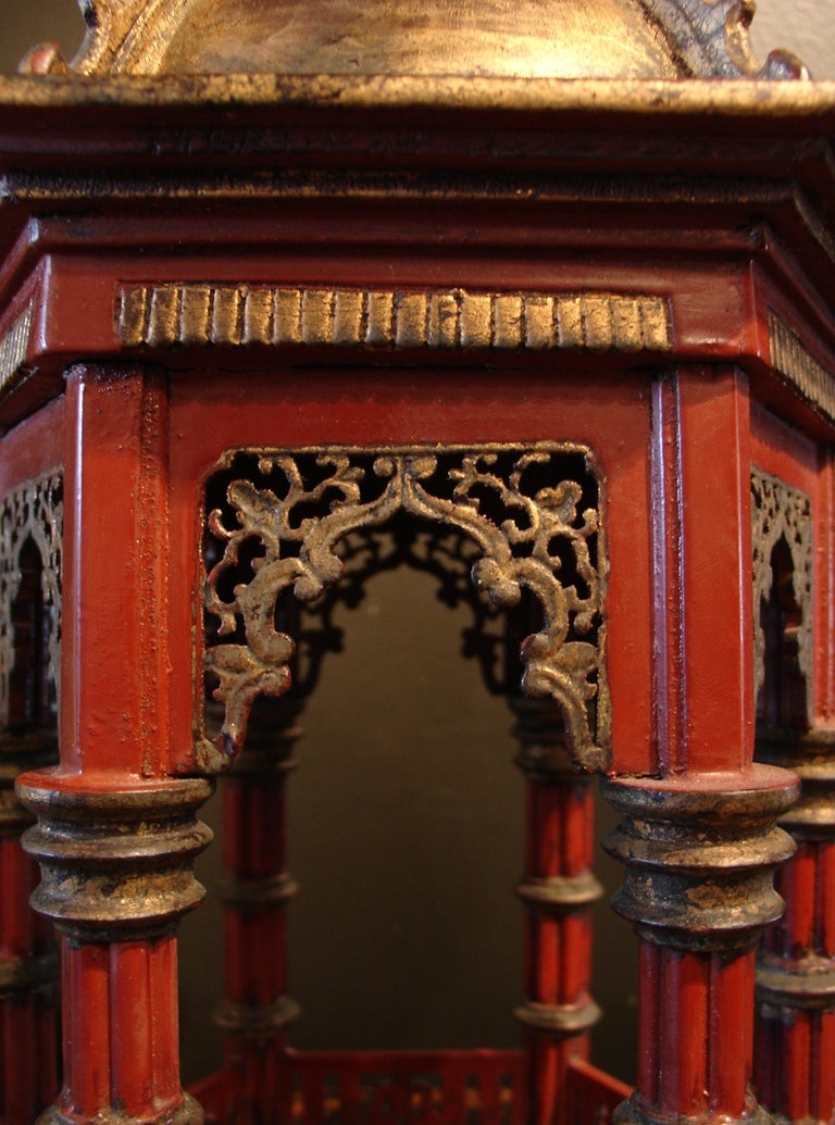 A highly detailed architectural model of a pavilion in the Chinoiserie taste.

The vermillion red open, hexagonal pavilion is topped by a gilt domed roof supported by columns of simulated bamboo on a stepped base.