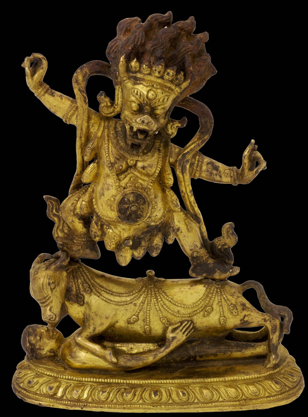 Yama Dharmaraja (lit. Lord of Death, King of the Law), the pot bellied, buffalo headed deity, is depicted in a powerful stance atop his vehicle, the buffalo, who rests on a prostrate human figure, representing perseverance over ignorance and worldly