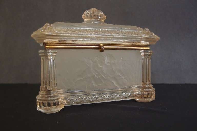 A fine cut and etched glass lidded table casket by Baccarat. The corners decorated as columns of cut glass. The sides feature etched glass panels with decorations of putti.