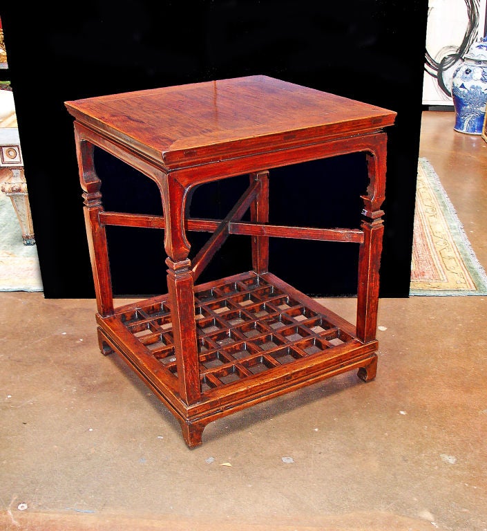 An interesting Chinese table in two sections. Together, the two sections form a nice, square side table with a cross support in the middle, and a lattice work base.



Separately, the top can be used a low 