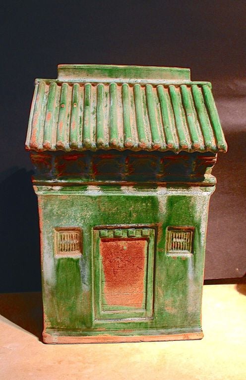 An unusually large Ming Dynasty green glazed model of a multi-story storehouse. Realistically molded with a tiled, gabled roof, door, and shuttered windows.  <br />
<br />
Most likely part of a larger model of a full scale courtyard home or larger