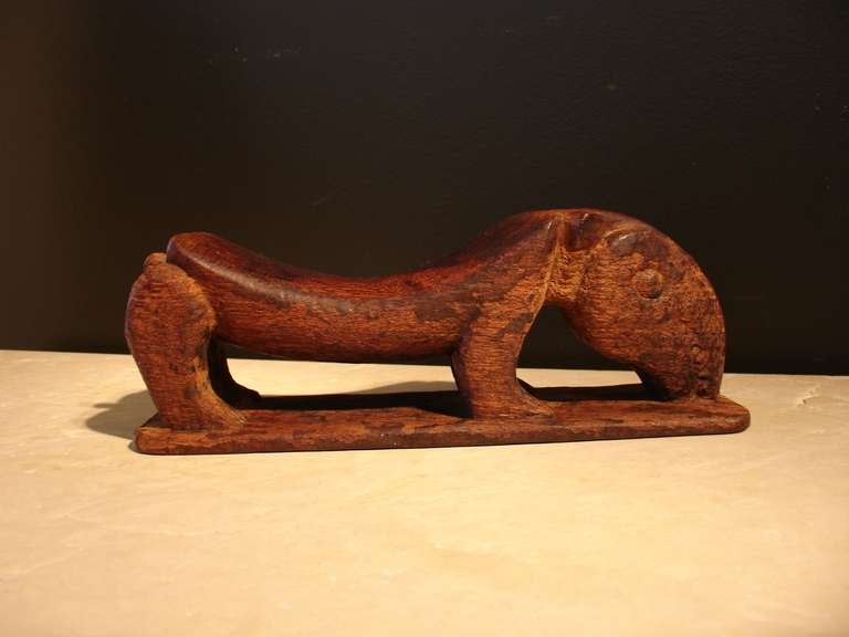 A whimsical and intriguing headrest carved from a single piece of hardwood in the form of an anteater. The curved back of the animal would have supported the neck and displays a wonderfully warm patina from tribal use.
The anteater's over sized
