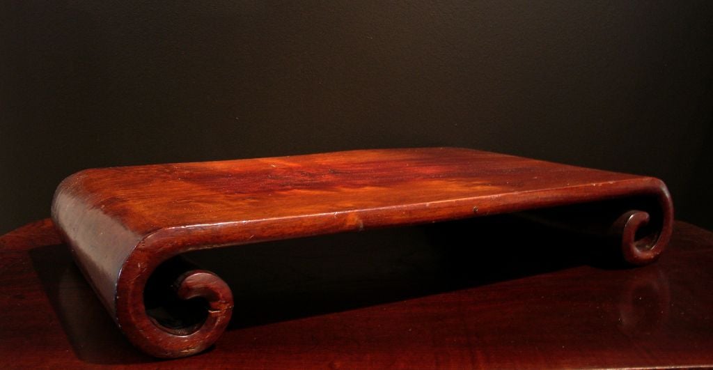 A large and solid scroll end stand (ji), made from a single plank of turned huanghuali wood 7/8