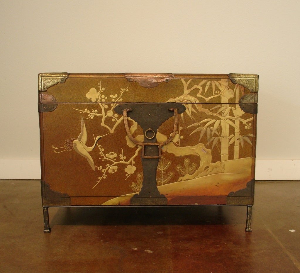 A very fine Japanese lacquer chest featuring a design in making of cranes, bamboo and plum blossoms in low relief with mother-of-pearl embellishments. The interior lined with silk brocade and featuring a single fitted tray of nashiji lacquer.
