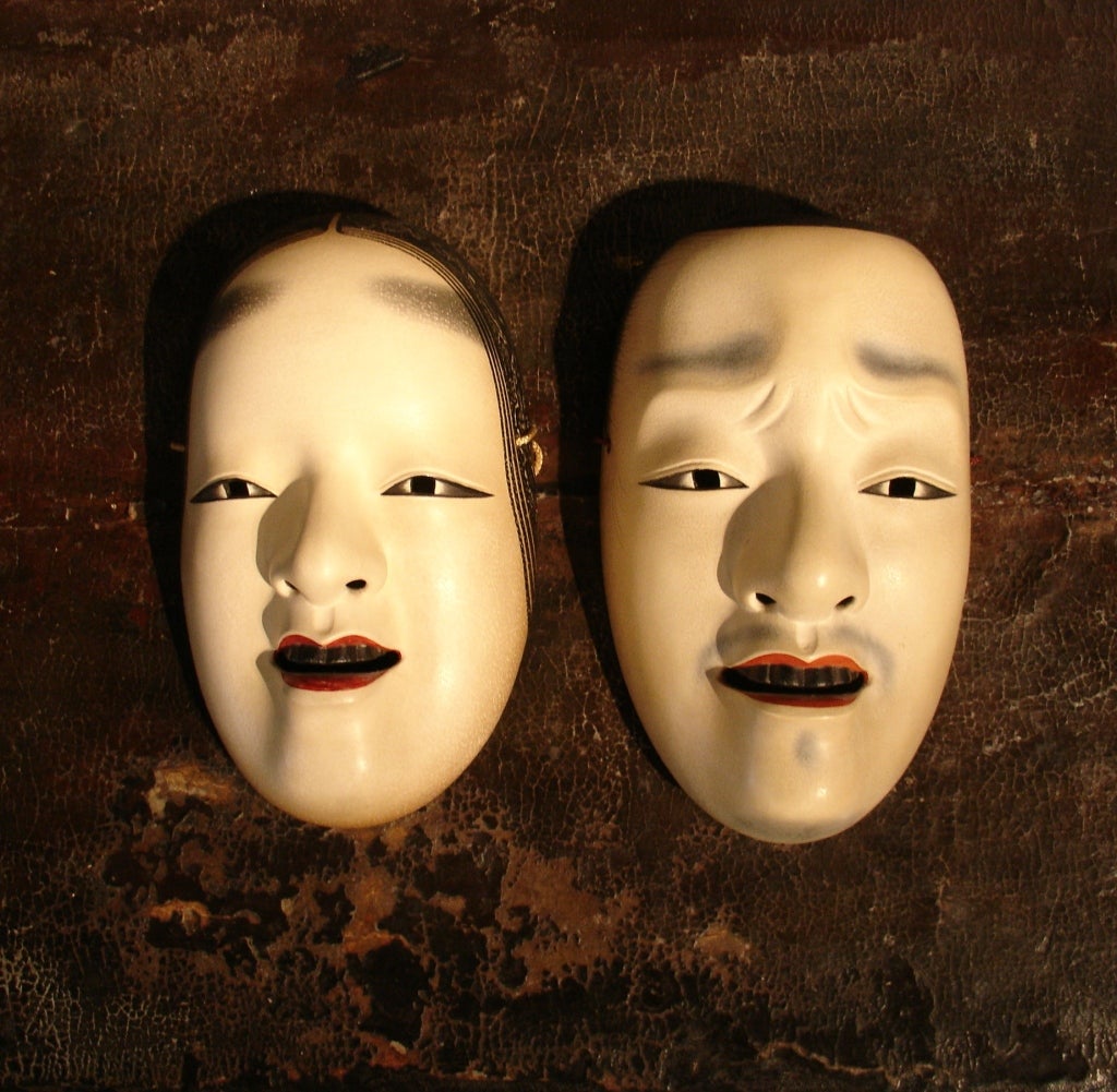 A very fine pair of Japanese noh theater masks. 

The female depicts Ko-omote, the youthful maiden. She has fine soft and rounded features. Her full lips slightly parted to reveal blackened teeth, a sign of nobility and beauty from the Heian era.