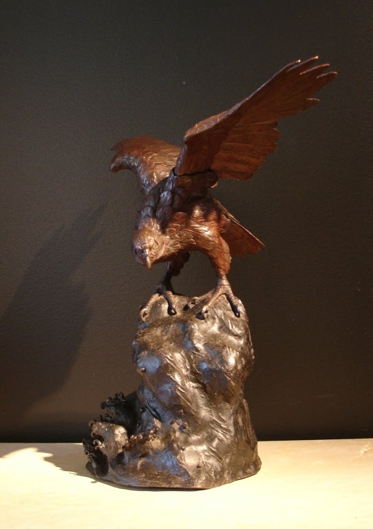 A wonderfully rendered bronze sculpture of an osprey or sea hawk. Perched on a rocky outcropping with majestic wings outspread, the bird of prey stares out intently at the crashing waves.
Artist's signature to the back of the base.