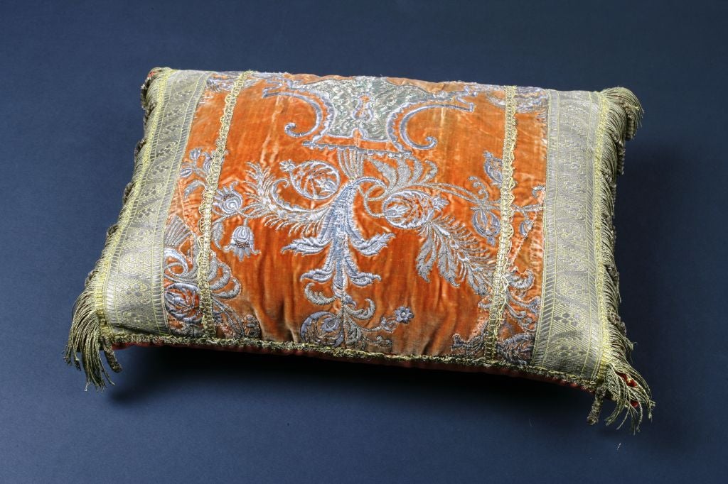 An antique Ottoman Empire textile fragment of rich burnt orange silk velvet with silver metallic micro-embroidery made into a pillow.