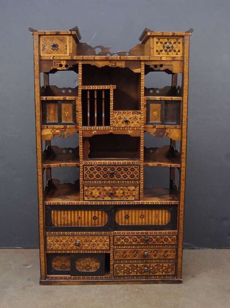 A very fine Japanese marquetry shadona. 

Elaborate and detailed marquetry work in a variety of woods and patterns provides a wonderful contrast in color and texture to the elegant keyaki (Japanese Elm) frame. 

Featuring nine drawers and four