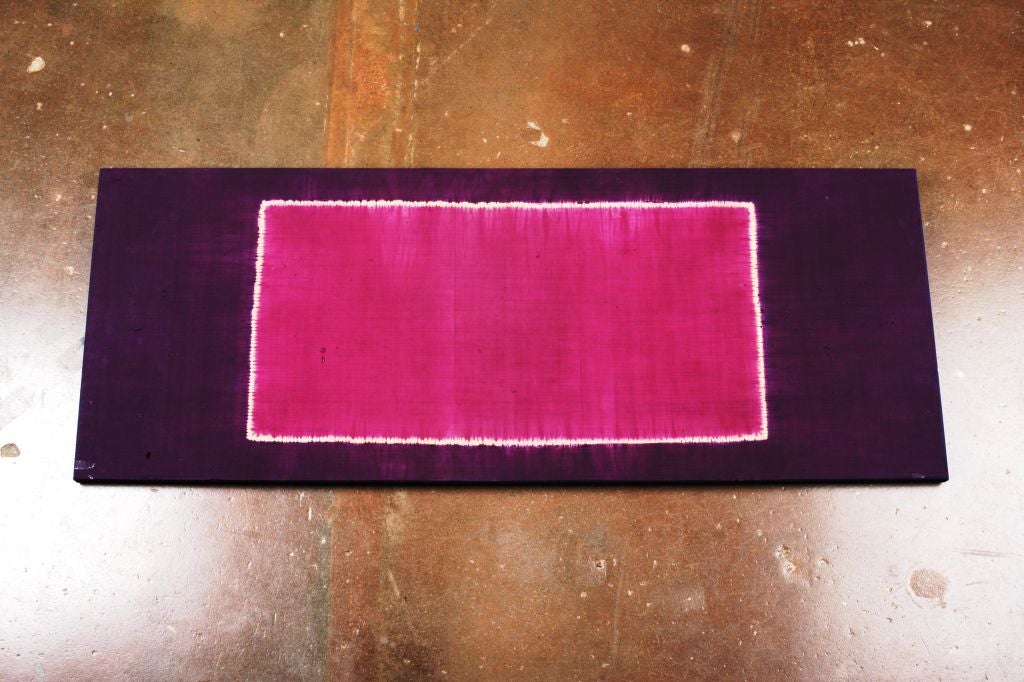 An Indonesian ceremonial silk shawl, called a lawon, mounted as textile art. Known in the west as Rothko textiles for their similarity to Rothko color field paintings. This one in deep purple and magenta. Resist dyed using the tritik, or stitch,
