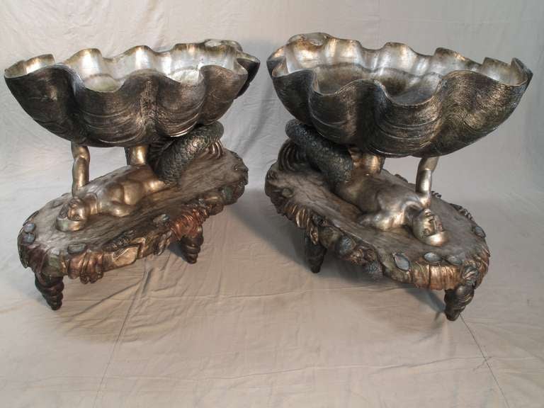 A fabulous pair of Venetian silver gilt and polychromed jardinières carved in the fantasy grotto style, Venice, Italy, early 20th century.

Hand carved from wood with silver and polychrome gilding, the jardinières or planters take the form of a