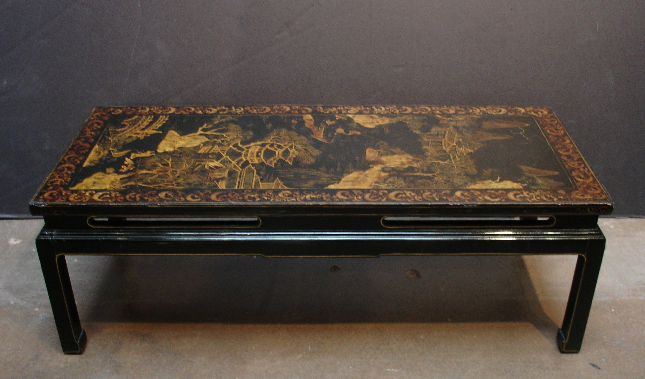 A Chinoiserie Black Lacquer and Gilt Decorated Coffee Table