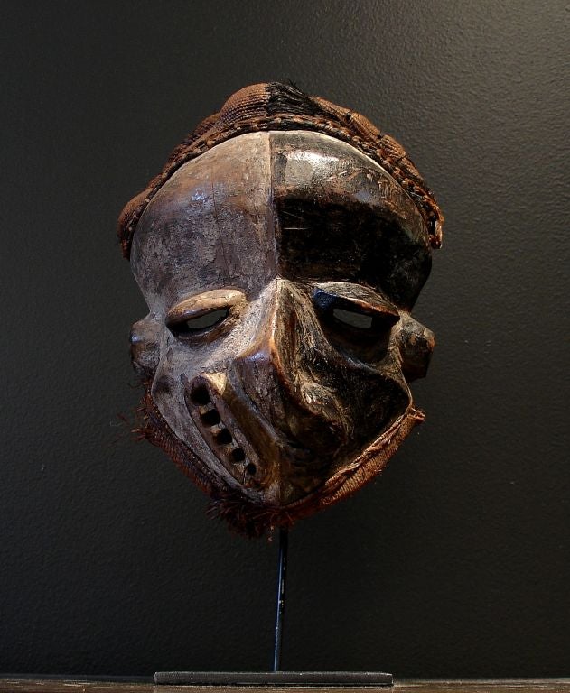 A striking and powerful mask from the Pende people of the Congo (now the Democratic Republic of the Congo). <br />
<br />
Representing a hunter stricken by disease and sickness as a result of witchcraft or sorcery, this mask is meant as a morality