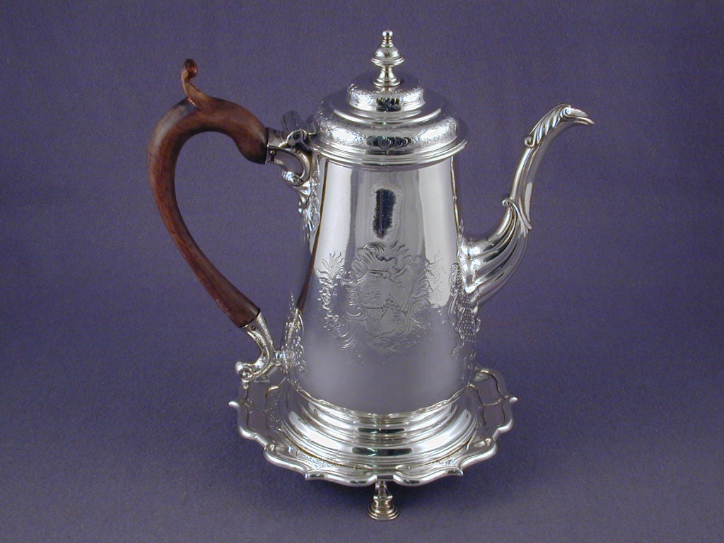 George II period Sterling Silver Coffee Pot on Stand, hallmarked: Isaac Cookson, Newcastle 1742<br />
Arms of Coxon of Morpeth impaling Carr, Northumberland