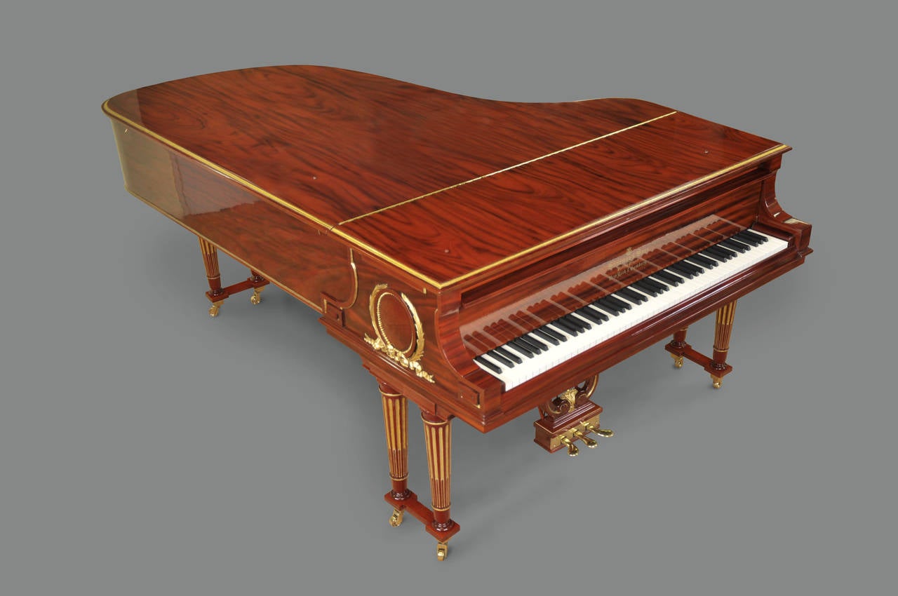 This piano has been fully restored to the highest industry standards and is in concert-ready condition.  It is fully refinished in mahogany and 24-karat gold leaf ornaments.