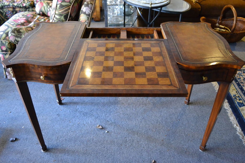 This is a wonderful banded and inlaid game table made by Maitland Smith, a company that specializes in the use of leather in its furniture. The checker/chessboard can be reversed so that it matches the rest of the table, of it can be removed to