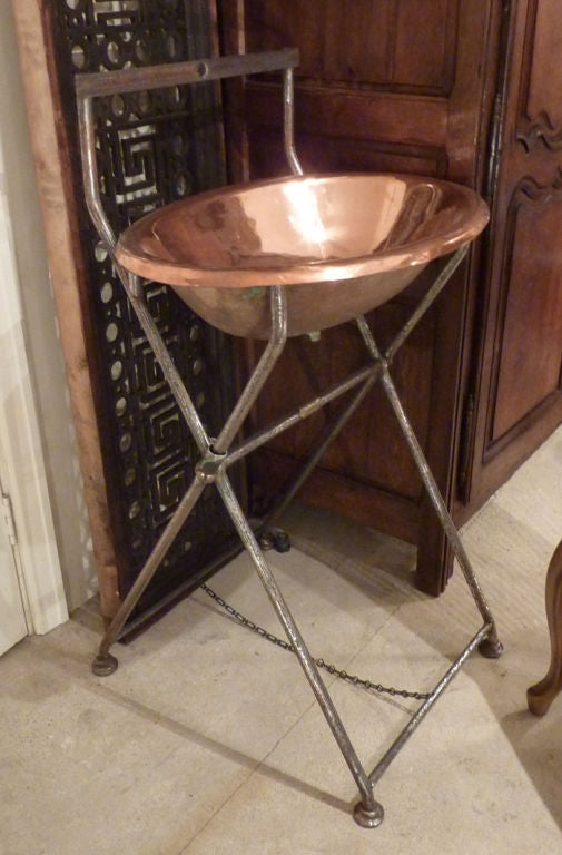 Portable Washstand with polished copper Basin on folding Iron stand with Brass plug hole. Brass label with makers name 