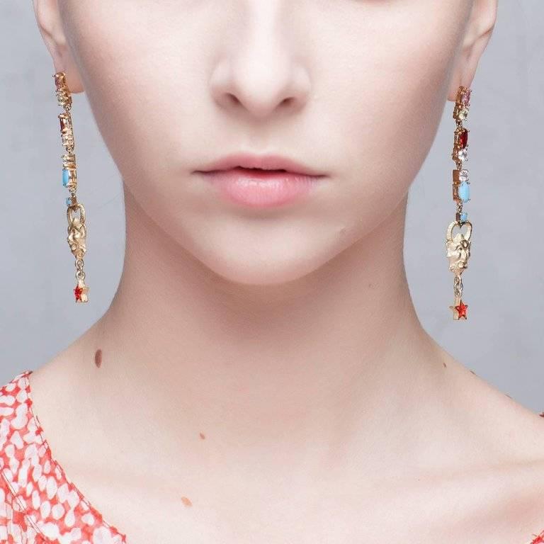 Playful and irreverent, these pieces from Iosselliani take inspiration from the Italian Fine Arts and feature small satyr's face adorned by  dangling Swarovski red stars.  Earrings are beautifully highlighted with colorful glass crystals and