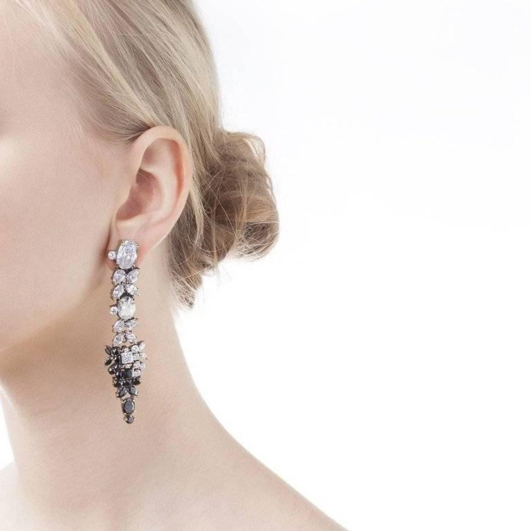 Iosselliani's tribute to the early 80's love for optical! Black and white cubic zirconia in a specular setting for a stunning pair of chandelier earrings. Crafted with a pierce and clip combination, the earrings will add extra grandeur to your gown.
