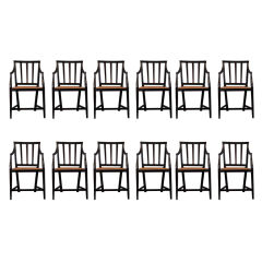 A set of 12 chairs in solid ebony